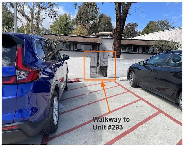 view of parking / parking lot with fence