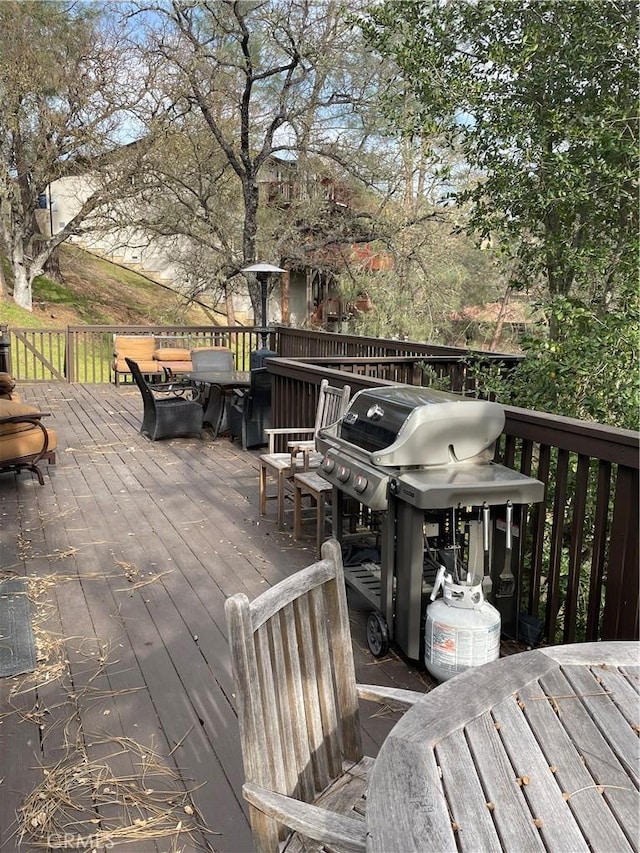 wooden terrace with a grill