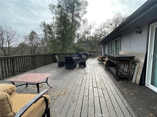 wooden deck featuring outdoor dining area