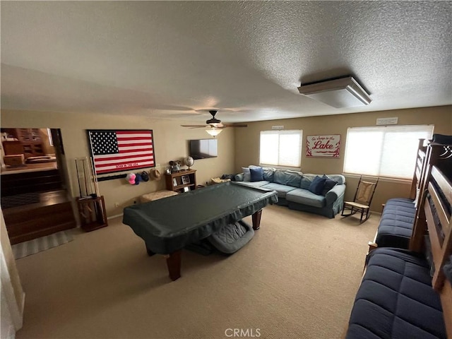 game room featuring a textured ceiling, billiards, a ceiling fan, and light carpet