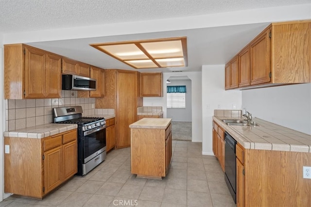 kitchen with a center island, stainless steel appliances, decorative backsplash, a sink, and a textured ceiling