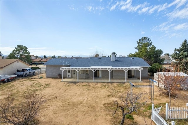 rear view of property featuring a patio area, fence, and a pergola