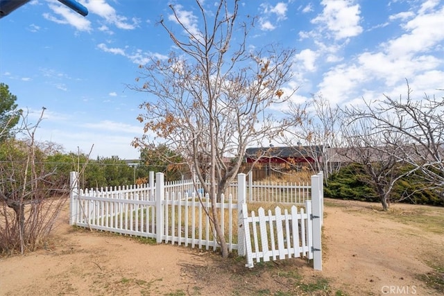 view of gate with a fenced front yard