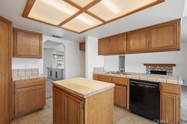 kitchen with visible vents, arched walkways, dishwasher, and light tile patterned flooring