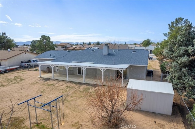 back of house featuring fence, a pergola, and a patio