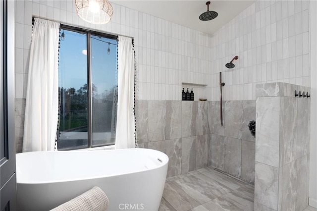 full bath with lofted ceiling, a freestanding tub, tiled shower, and tile walls