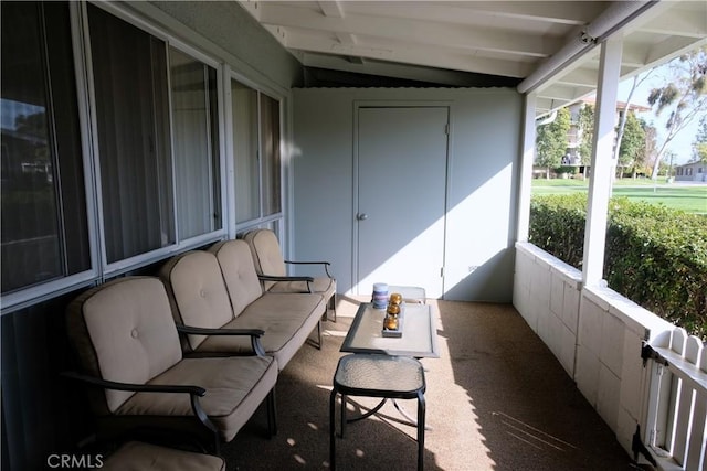 sunroom featuring lofted ceiling