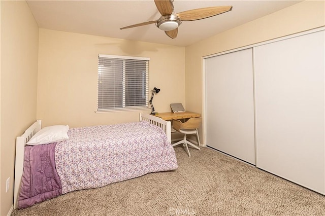 carpeted bedroom featuring a ceiling fan and a closet