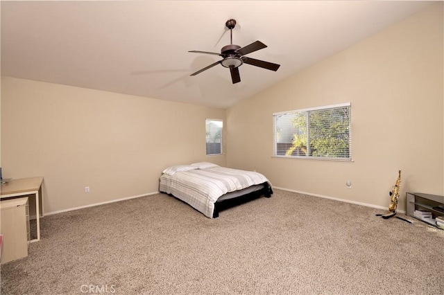 bedroom with carpet floors, vaulted ceiling, baseboards, and a ceiling fan