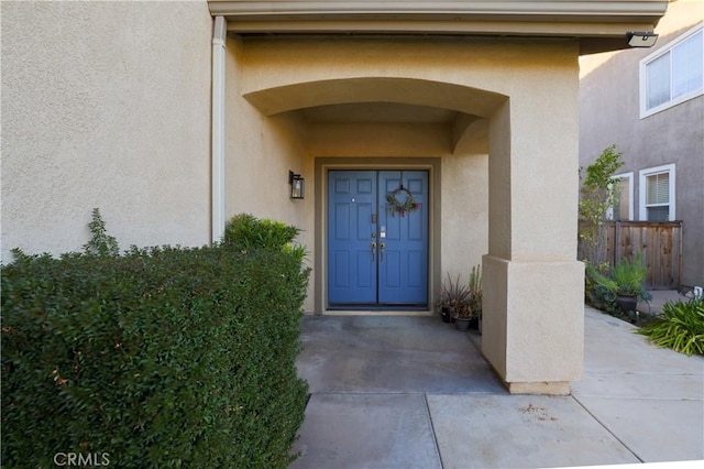 doorway to property with stucco siding