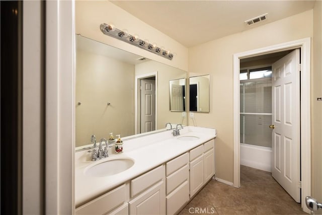 full bath with double vanity, tile patterned flooring, a sink, and visible vents