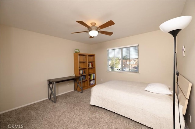 carpeted bedroom with ceiling fan and baseboards