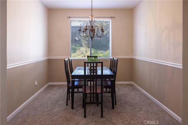 carpeted dining area featuring a chandelier and baseboards