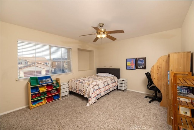 carpeted bedroom featuring a ceiling fan and baseboards