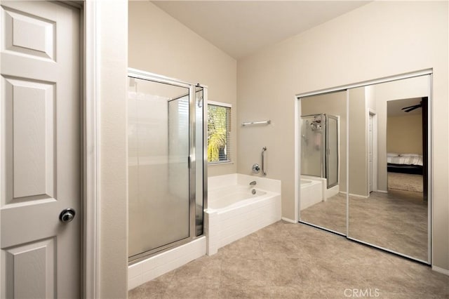 full bath with a stall shower, a garden tub, and lofted ceiling