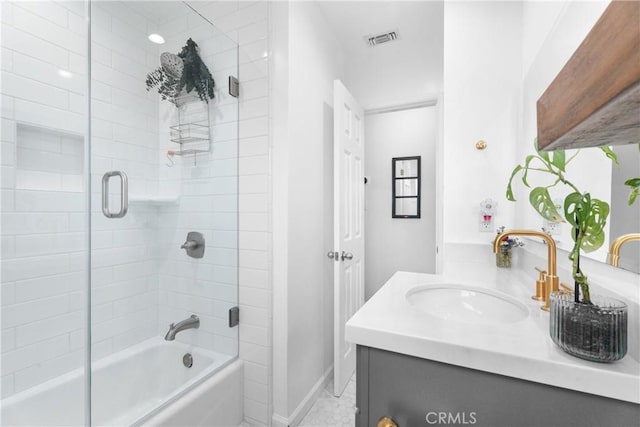 full bathroom featuring visible vents, enclosed tub / shower combo, baseboards, and vanity