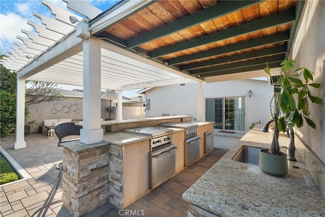 view of patio / terrace featuring area for grilling, fence, a pergola, and a sink