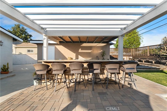 view of patio / terrace featuring fence and a pergola