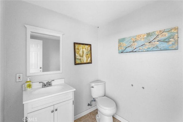 half bath with baseboards, toilet, and vanity