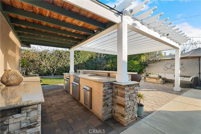 view of patio with a sink, a pergola, and an outdoor kitchen