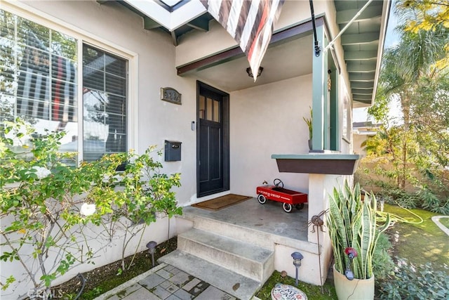 doorway to property with stucco siding