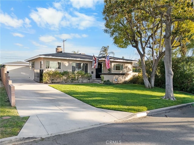 ranch-style home featuring stucco siding, an outbuilding, a chimney, and a front lawn