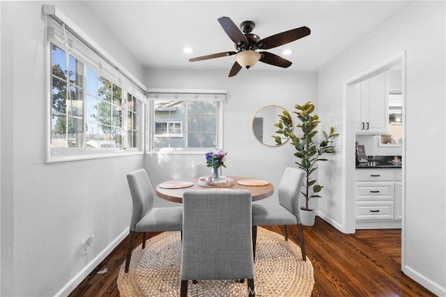 dining space with recessed lighting, dark wood-type flooring, and baseboards