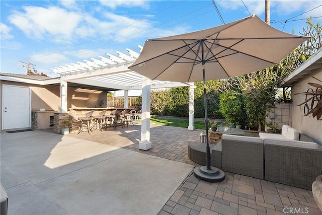 view of patio featuring an outdoor living space, fence, a pergola, and outdoor dry bar