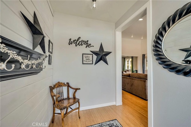 hallway with baseboards and wood finished floors