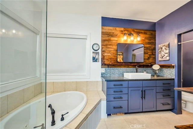 bathroom featuring vanity, a tub with jets, and tile patterned floors