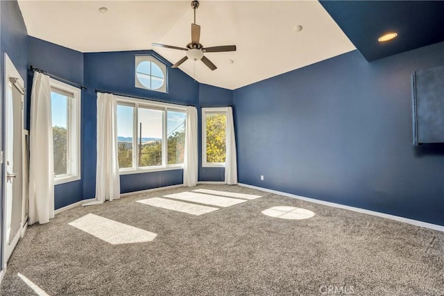 spare room featuring vaulted ceiling, carpet, and baseboards