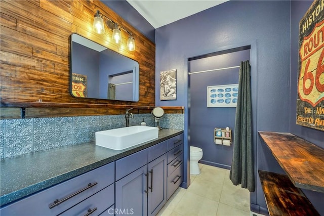 full bath featuring toilet, vanity, decorative backsplash, and tile patterned floors