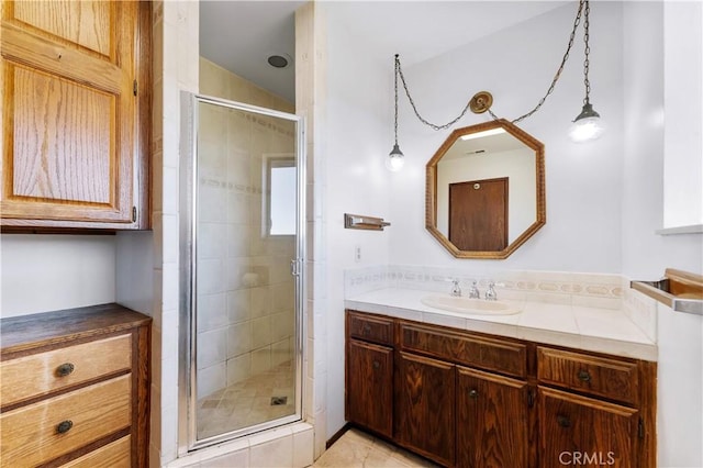 bathroom featuring a shower stall and vanity