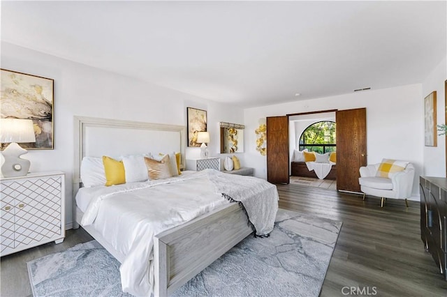 bedroom with visible vents and wood finished floors