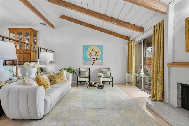 living room with vaulted ceiling with beams, a brick fireplace, and visible vents