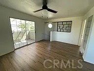 unfurnished living room featuring ceiling fan and wood finished floors