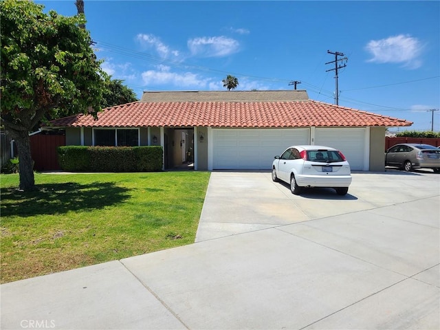 ranch-style home featuring a garage, a tiled roof, concrete driveway, and a front yard