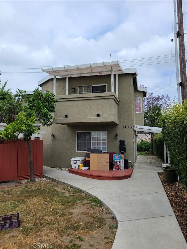 exterior space featuring fence and stucco siding