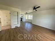 empty room featuring a ceiling fan and wood finished floors