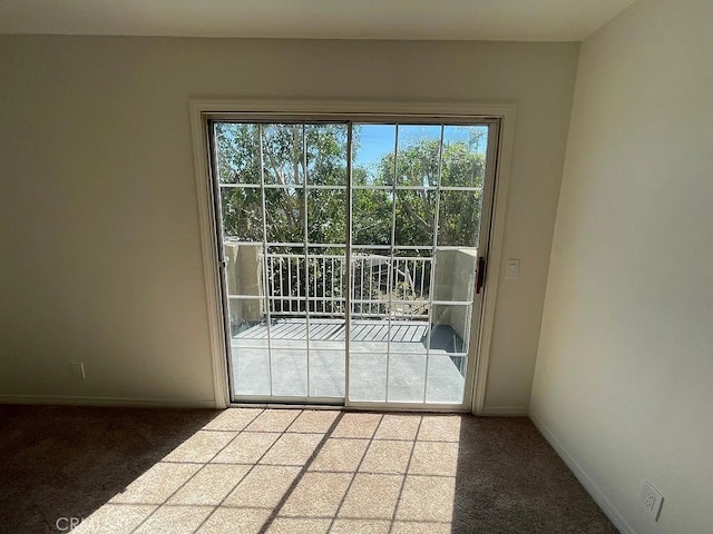 doorway to outside with carpet floors and baseboards