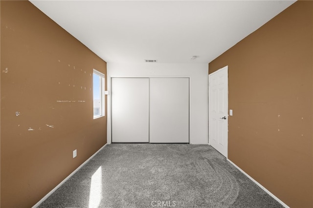 unfurnished bedroom featuring a closet, visible vents, and baseboards