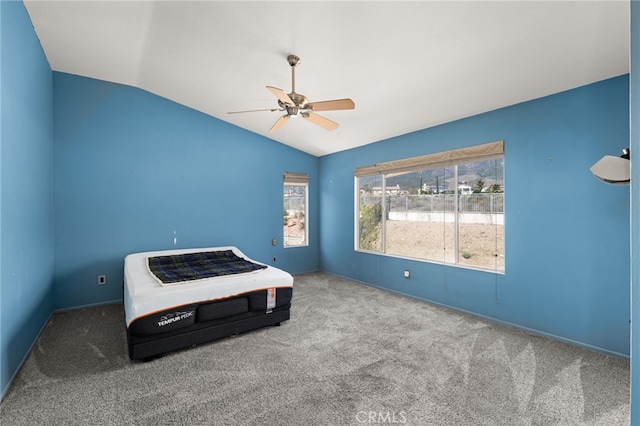 unfurnished bedroom featuring lofted ceiling, ceiling fan, and carpet flooring