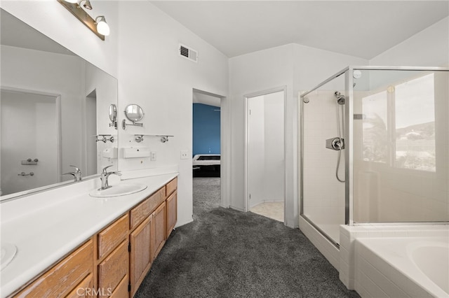 full bathroom with a stall shower, visible vents, a sink, and double vanity