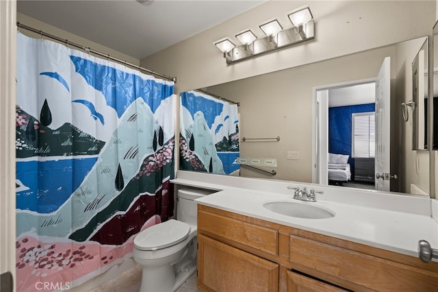 ensuite bathroom featuring vanity, toilet, and ensuite bathroom