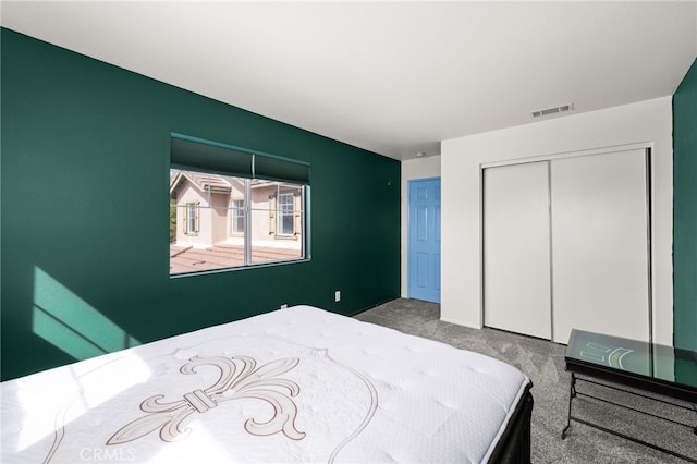 carpeted bedroom with a closet and visible vents