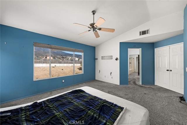 unfurnished bedroom with visible vents, a ceiling fan, lofted ceiling, ensuite bath, and carpet