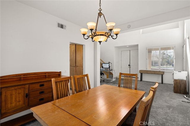 carpeted dining area featuring a chandelier and visible vents