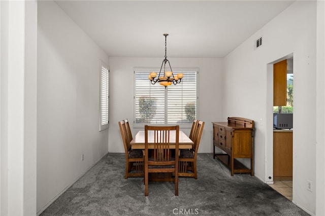 dining area with light carpet, visible vents, and a notable chandelier