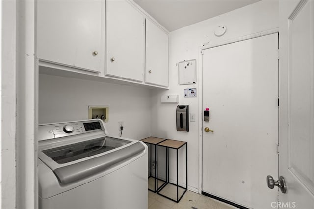 clothes washing area featuring washer / dryer and cabinet space