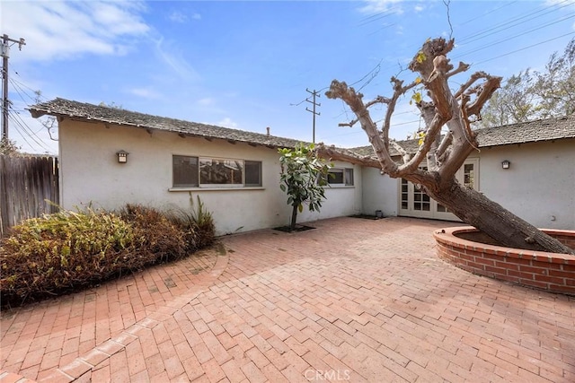 back of property featuring fence, a patio, and stucco siding